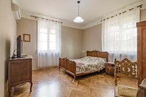 a bedroom with a bed and a tv in it at Апартамент Жасмин in Varna City
