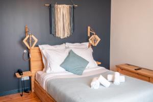 a bedroom with a bed with two towels on it at AUBERGE KOSKENIA in Bidart