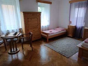 a bedroom with a small table and a bed and a table and chair at Ferienwohnung Veljanovski in Blaufelden