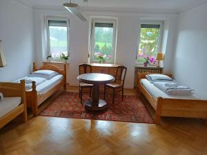 a room with two beds and a table in it at Ferienwohnung Veljanovski in Blaufelden