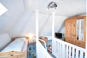 a childs room with a crib in a attic at Morgenröte in Norddeich