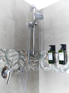 a shower in a bathroom with two bottles of soap at [RHO FIERA] Apartment near the Metro in Pero