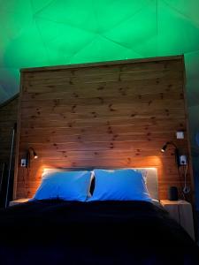 a bedroom with a large wooden headboard and a bed at Olden Glamping - One with nature in Stryn