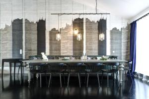 a dining room with a large table and chairs at Gorki Apartments in Berlin