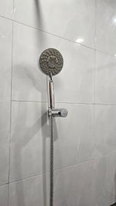 a shower with a shower head in a wall at Luxurious 2 BHK Apartment Fully Furnished with All Major Electronics and Automation in Pune