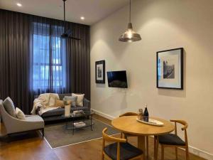 a living room with a couch and a table at New York on Moorabool - Free Wi-Fi in Geelong