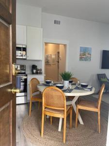 a kitchen with a dining room table and chairs at Elegant Duplex Steps to Forsyth! in Savannah