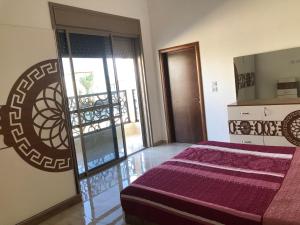 a bedroom with a bed and a sliding glass door at Old Jericho homestay in Jericho