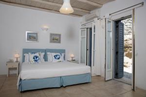 a bedroom with a large bed in a room at Lia beach Estate in Mikonos +37 photos