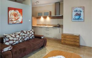 a living room with a couch and a kitchen at Nice Home In Bytw With Wifi in Bytów