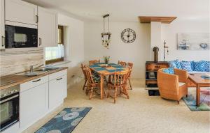 a kitchen and dining room with a table and chairs at Amazing Home In Prerow With Wifi in Prerow