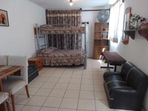 a living room with a bunk bed and a couch at Sweet Home in Tequisquiapan