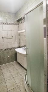 a bathroom with a shower and a sink and a toilet at Ratuszowy in Włocławek