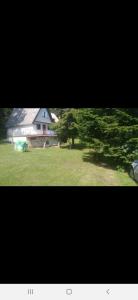 een foto van een huis en een tuin met bomen bij AWilaBorova# in Zlatibor