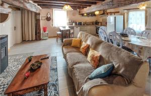 a living room with a couch and a table at Gîte Aux Hirondelles in Pouilly-sous-Charlieu