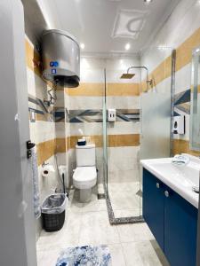 a bathroom with a toilet and a shower and a sink at Studio House 589-5 in 6th Of October