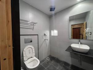 a bathroom with a toilet and a sink at Pokhara Backpackers Hostel in Pokhara