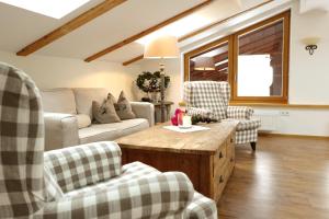 a living room with a couch and two chairs at Hotel Maier zum Kirschner in Rottach-Egern