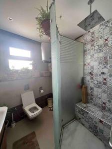 a small bathroom with a toilet and a window at Newly refurbished flat,Marble floors.Central Cairo in Cairo