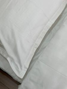 a close up of a white bedsheet at Apart Inn - Апарт Отель in Uralsk