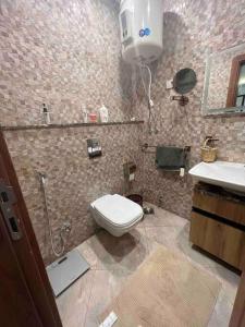 a bathroom with a toilet and a sink at Newly refurbished flat,Marble floors.Central Cairo in Cairo