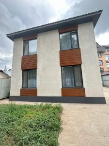 a house with three windows on the side of it at Apart Inn - Апарт Отель in Uralsk