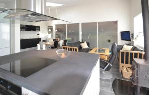 a kitchen and living room with a black counter top at Nice Home In Hvide Sande With Kitchen in Hvide Sande