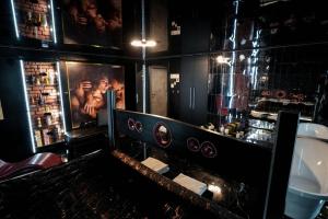 un bar con una foto de un hombre en la pared en Grey Secret Champagne Apartament Spa en Gdansk