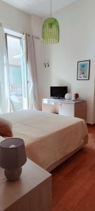 a bedroom with a large bed and a television at Il Quadrifoglio Room& Suite in Palermo