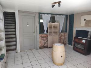 a room with a door and a stove and a barrel at Gite du Dolmen classé 3 épis in Blessac