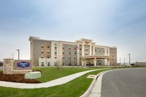 a large building with a sign in front of it at Hampton Inn By Hilton Wichita Northwest in Wichita