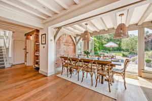 an open dining room with a table and chairs at Bedgebury Oast by Bloom Stays in Goudhurst