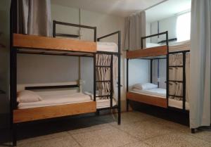 two bunk beds in a room with a window at Happy Taipei Hostel - Share House - Monthly in Taipei +23 photos