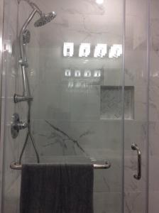 a shower with a glass door with a towel at Cozy Canarsie Getaway Brooklyn NY in Brooklyn