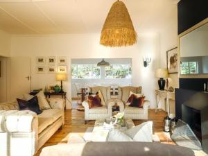 a living room with two couches and a table at Land's End Private Game Reserve in Grahamstown