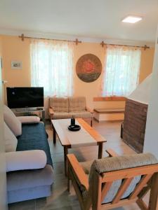 a living room with a couch and a table at Oázis Vendégház in Gyula