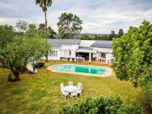 an aerial view of a house with a pool and a yard at Land's End Private Game Reserve in Grahamstown