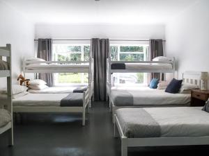 a group of bunk beds in a room with a window at Land's End Private Game Reserve in Grahamstown