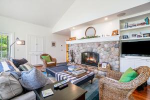 a living room with a couch and a fireplace at Blue Bear in Glen Arbor