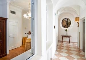 a hallway with a table and a mirror at Charles Bridge Palace in Prague