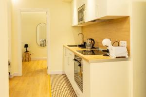 a kitchen with white cabinets and a counter top at BILBAO NORTH SHORE APARTMENTS 6 in Bilbao