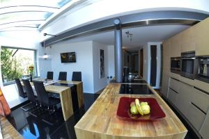 a kitchen with a table with a plate of fruit on it at AlpinDesign Kaunertal in Kaunertal