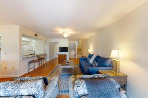 a living room with a blue couch and a table at Turnberry Village 291 in Hilton Head Island