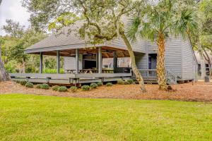 a house with a porch and a palm tree at Turnberry Village 291 in Hilton Head Island