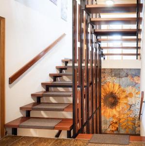 a staircase with wood treads and a mural on the wall at Ferienwohnung Sonnenblume 