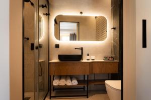 a bathroom with a sink and a mirror at Navria by Aetoma in Nafplio +102 photos