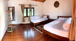 Postel nebo postele na pokoji v ubytování Bardia Eco Friendly Homestay