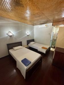 a room with two beds in a room at Lux Guesthouse in Phi Phi Islands