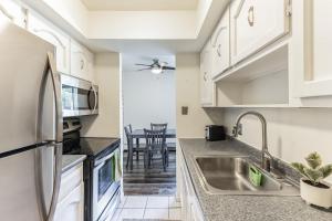 a kitchen with white cabinets and a sink at 1BR 1BA Apartment near U of M and Downtown in Ann Arbor