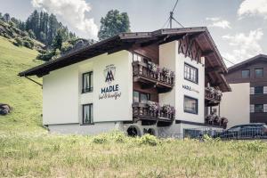 a building with a balcony on the side of it at Madle - B&B in Sölden